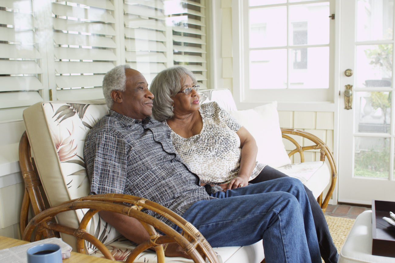 older couple on a bench on a deck