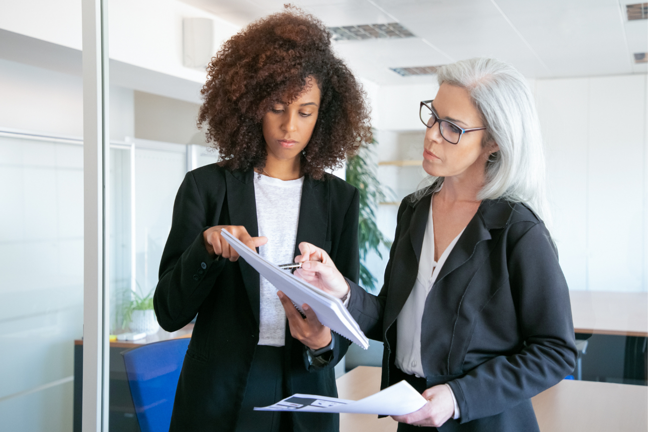 two business women looking at papers in office