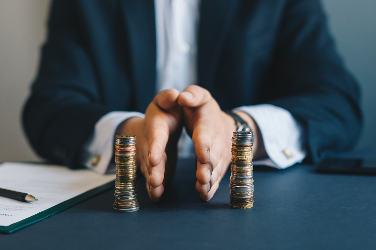 hands in between two vertical stacks of change