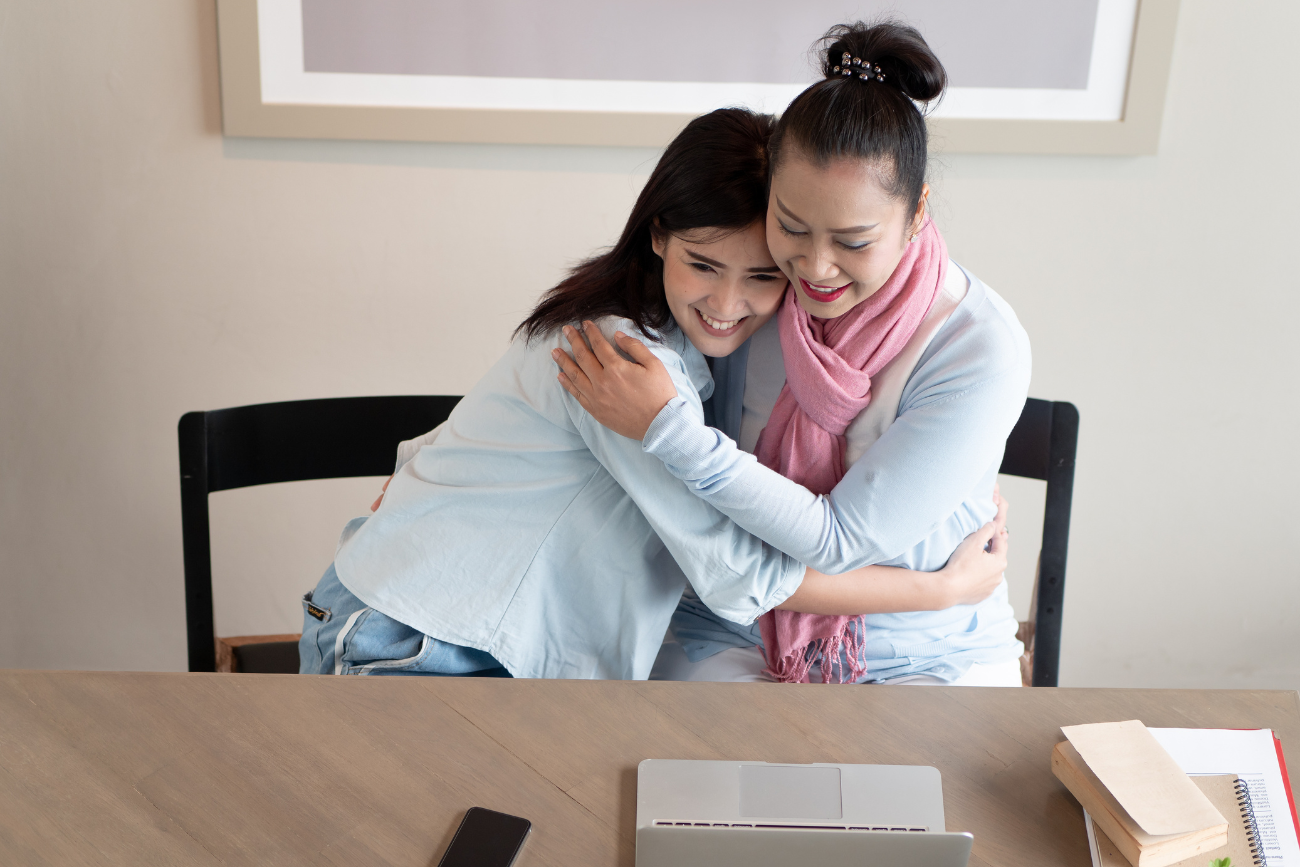 mother daughter watching video on laptop